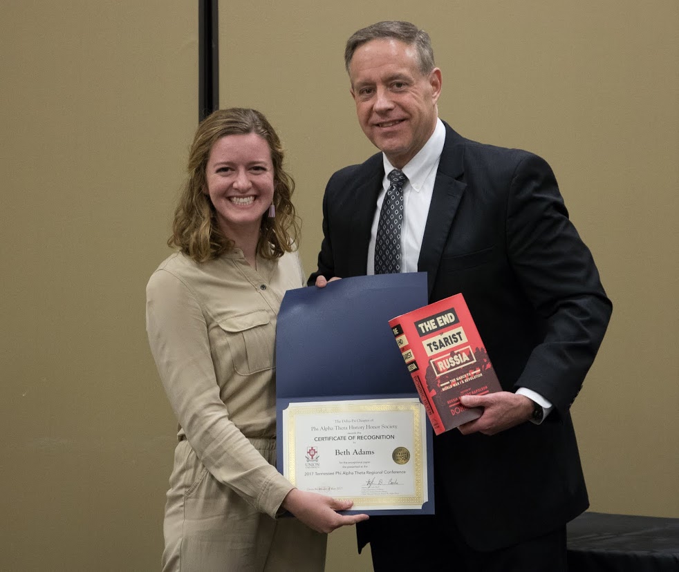 Beth Adams receives a book and a certificate of recognition from Dr. Henry Allen at the history awards banquet on May 4, 2017, for her paper presentation at the 2017 Tennessee Phi Alpha Theta Regional Conference on April 1. Photo by Janelle Vest