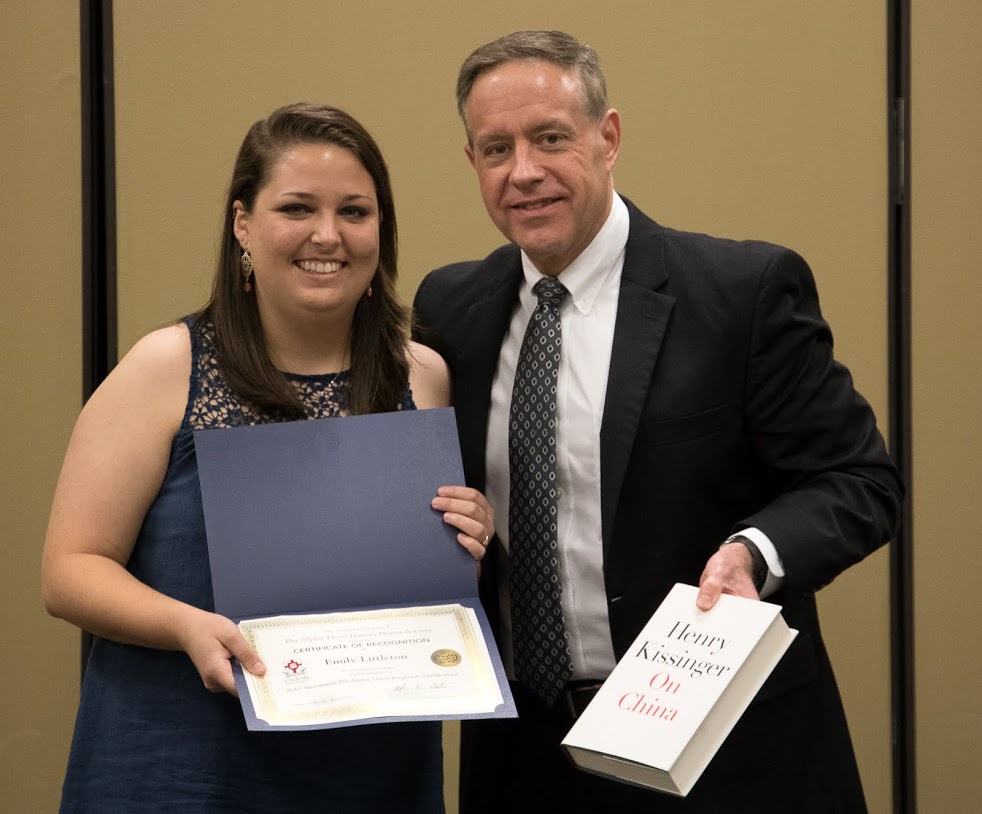 Dr. Henry Allen presents a book and certificate of recognition to Emily Littleton at the history awards banquet on May 4, 2017, for the paper she gave at the 2017 Tennessee Phi Alpha Theta Regional Conference on April 1. Photo by Janelle Vest