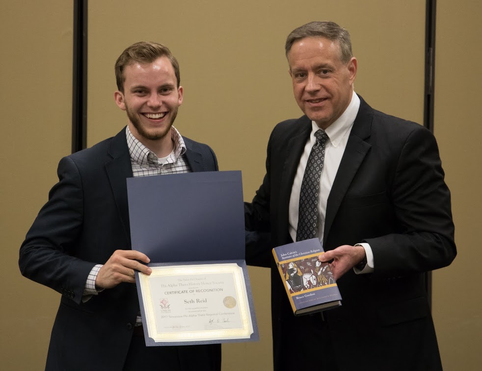 Seth Reid (left) accepts a book and a certificate of recognition from Dr. Henry Allen at the History Department Awards Banquet on May 4, 2017, for his paper presentation at the 2017 Phi Alpha Theta Regional Conference on April 1. Photo by Janelle Vest