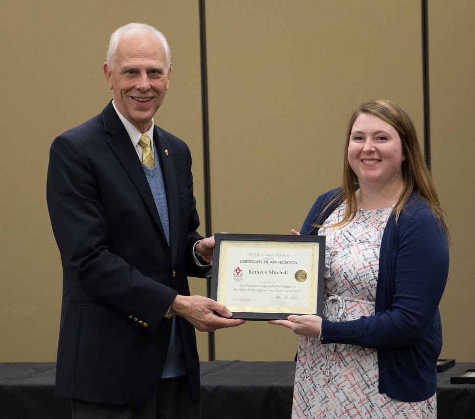 Dr. Stephen Carls gives a certificate of appreciation to Kathryn Mitchell at the history awards banquet on May 4, 2017, for her work as the 2016-2017 vice president of the Delta-Psi chapter of Phi Alpha Theta History Honor Society. Photo by Janelle Vest