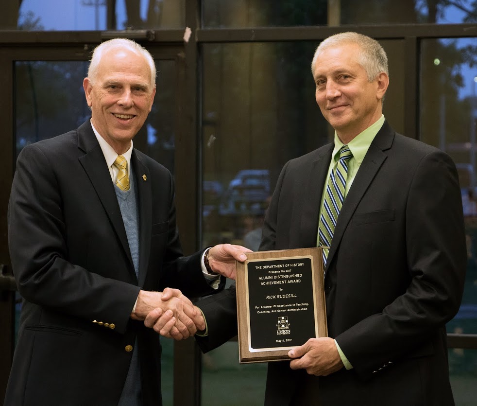 Rick Rudesill (right) accepts the 2017 History Alumni Distinguished Achievement Award from Dr. Stephen Carls at the History Department Awards Banquet on May 4, 2017. Photo by Janelle Vest