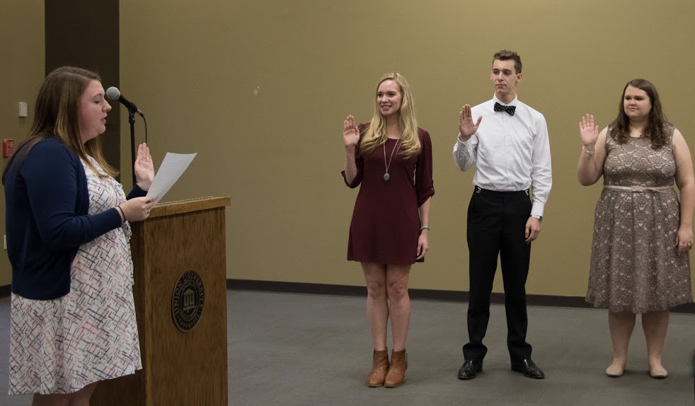 Rutledge Honorary History Club President Kathryn Mitchell (left) leads the induction ceremony of 2017-2018 club officers at the history awards banquet on May 4, 2017. The incoming officers are (left to right) Ali Renckens (president), Jonathan Greer (secretary), and Jessica Barton (vice president). Photo by Janelle Vest