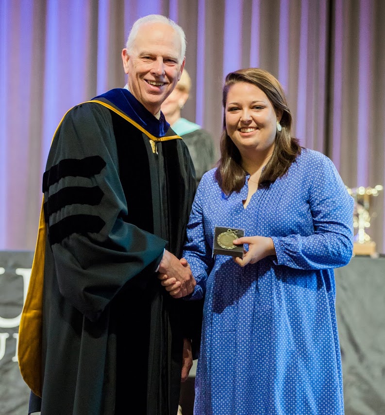 Emily Littleton accepts the Academic Excellence Medal in History from Dr. Stephen Carls at the Union University Awards Day Convocation on May 5, 2017. Photo by Kristi Woody