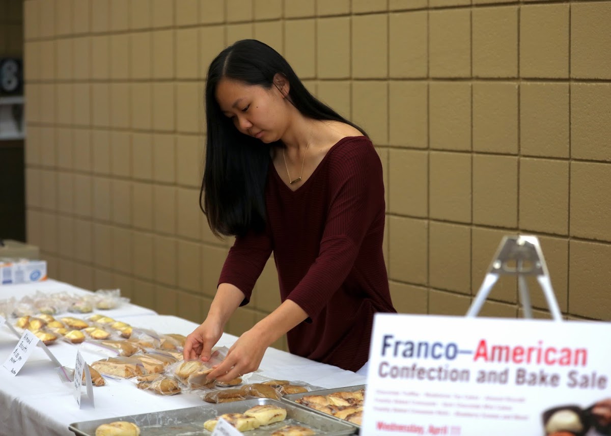 Katherine Cheshire arranges food items on the sales table near Barefoots Joe during the Phi Alpha Theta bake sale on April 11, 2018. Photo by Kristi Woody