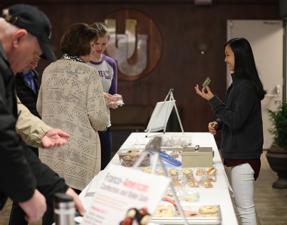 Katherine Cheshire waits on customers in the chapel foyer during the Phi Alpha Theta bake sale on April 11, 2018. Photo by Kristi Woody