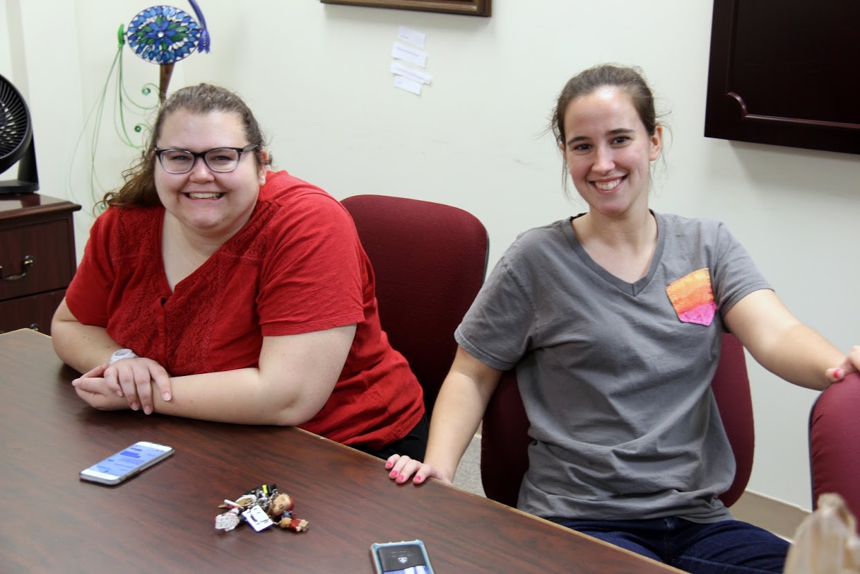 Jessica Barton (left) and Joanna Butcher relax as they wait for pizza at the Rutledge Honorary History Club's movie night on April 13, 2018.