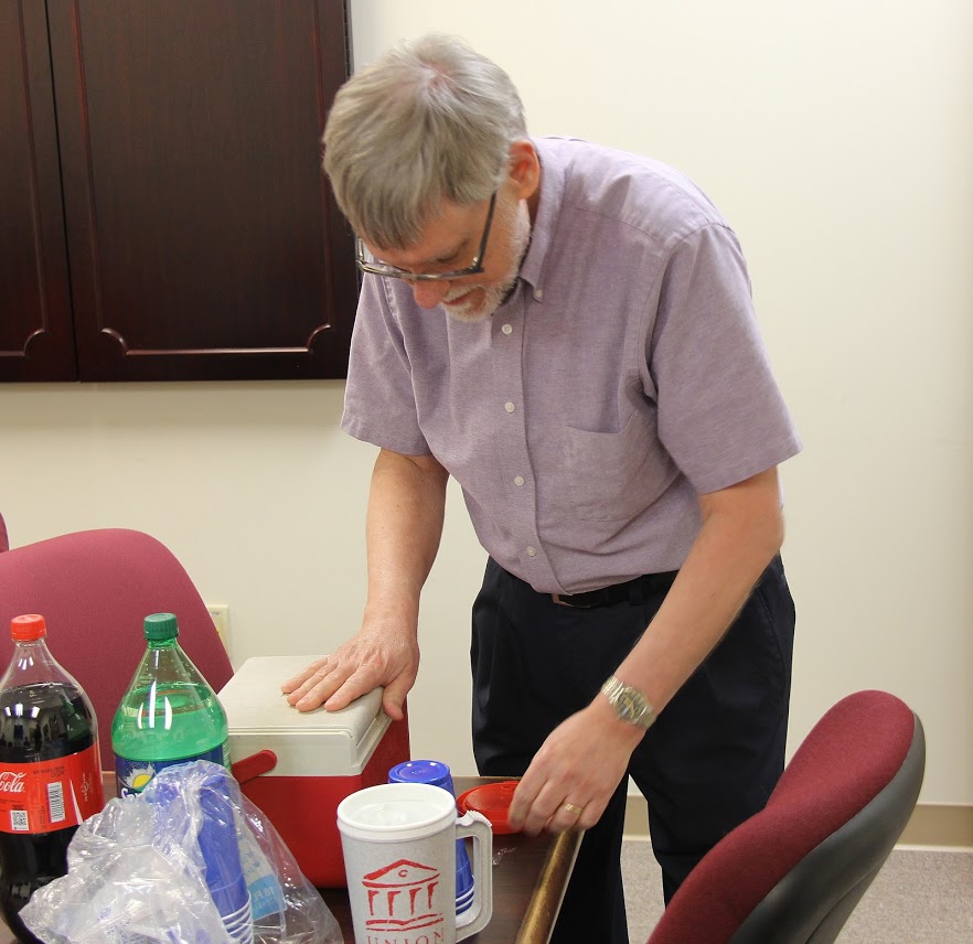 Dr. Terry Lindley gets ready to have some Coca Cola at the Rutledge Honorary History Club's movie night on April 13, 2018.