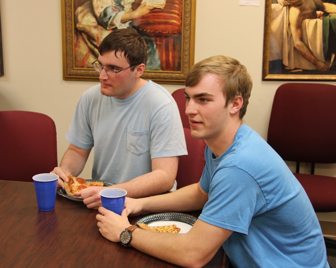 Miles Randall and Cameron Woodard enjoy pizza and soft drinks at the Rutledge Honorary History Club's movie night on April 13, 2018.