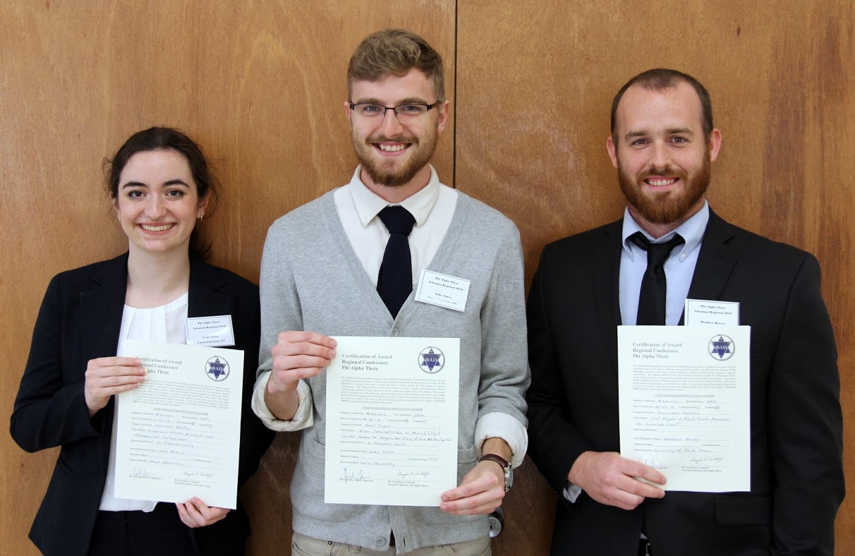 The three student paper prize winners at the Arkansas Phi Alpha Theta Regional Conference at the University of Arkansas at Monticello display their award certificates on April 7, 2018. They are (left to right) Leah Atkins (third place) and Luke Sower (first place) of Union University, and Matthew Harvey (second place) of the University of North Texas.