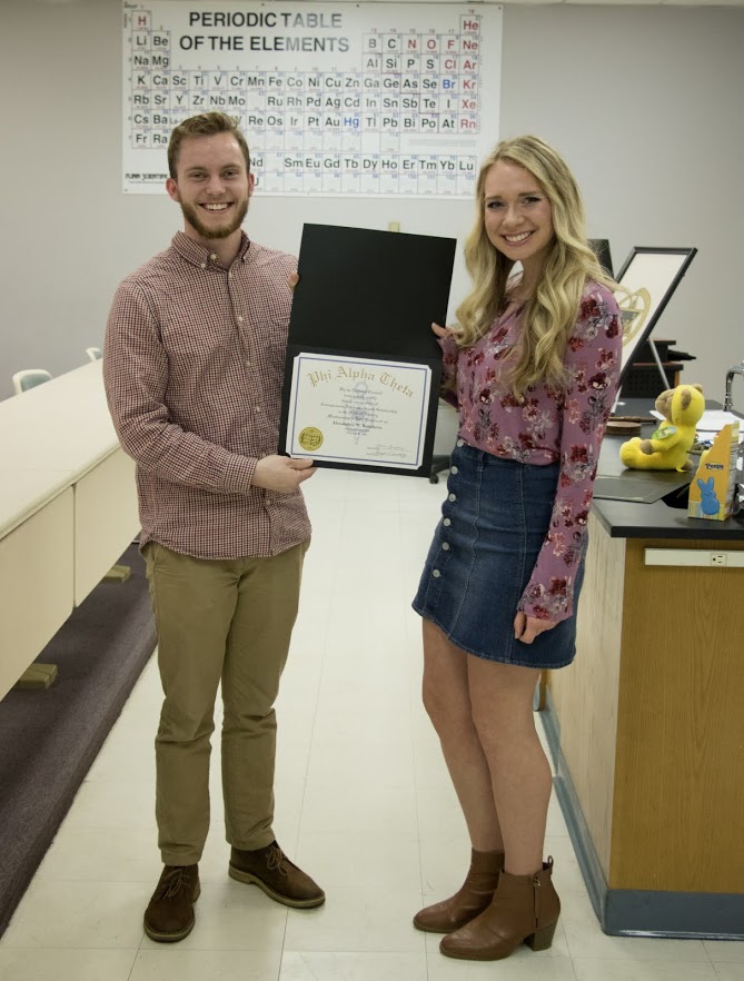 Delta-Psi President Seth Reid presents Ali Renckens with her Phi Alpha Theta membership certificate on February 27, 2018. Photo by Janelle Vest