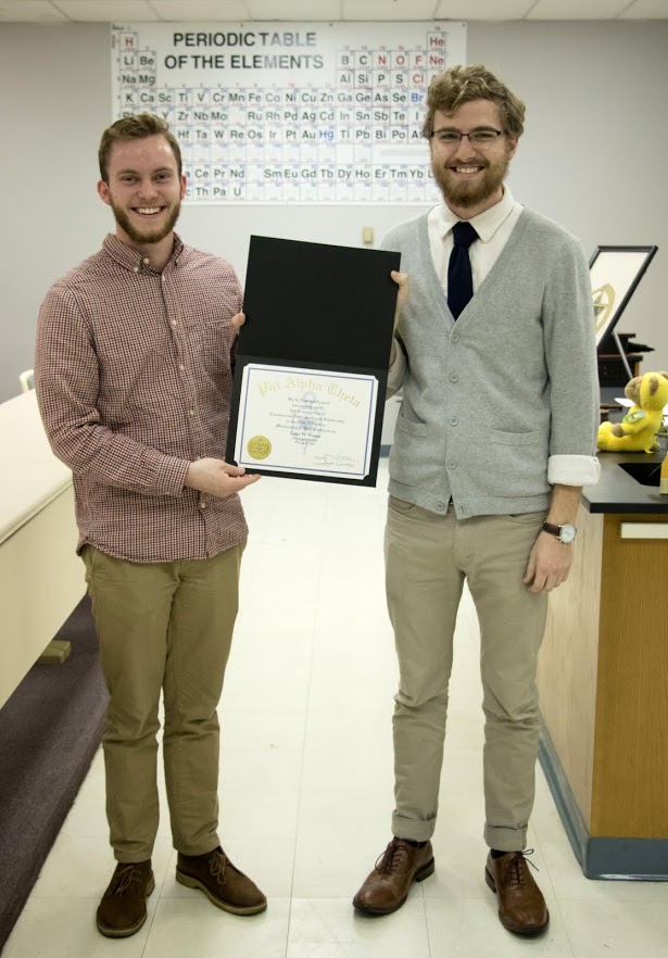 Luke Sower (right) accepts his Phi Alpha Theta membership certificate from Delta-Psi Chapter President Seth Reid on February 27, 2018. Photo by Janelle Vest