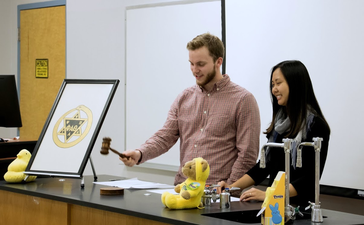 President Seth Reid begins the business segment of the Delta-Psi chapter's plenary meeting on February 27, 2018. Vice President Katherine Cheshire assists him. Photo by Janelle Vest