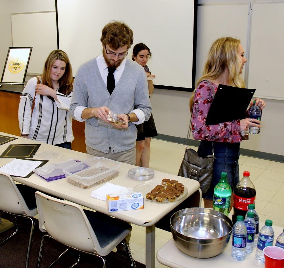 Students go through the refreshments line following the Phi Alpha Theta plenary meeting on February 27, 2018. In the foreground are (left to right) Alex Barger, Luke Sower, and Ali Renckens.