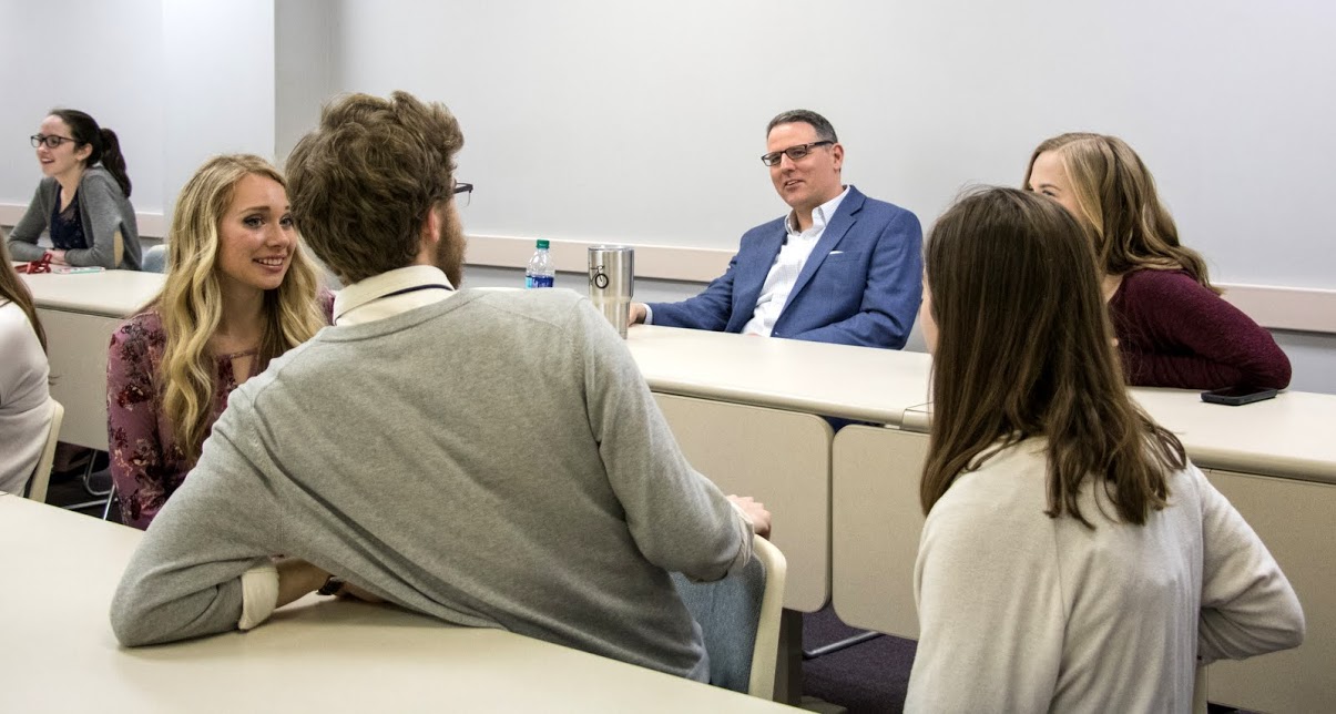 Attendees at the Phi Alpha Theta plenary meeting enjoy a group conversation prior to the start of the initiation ceremony on February 27, 2018. Photo by Janelle Vest