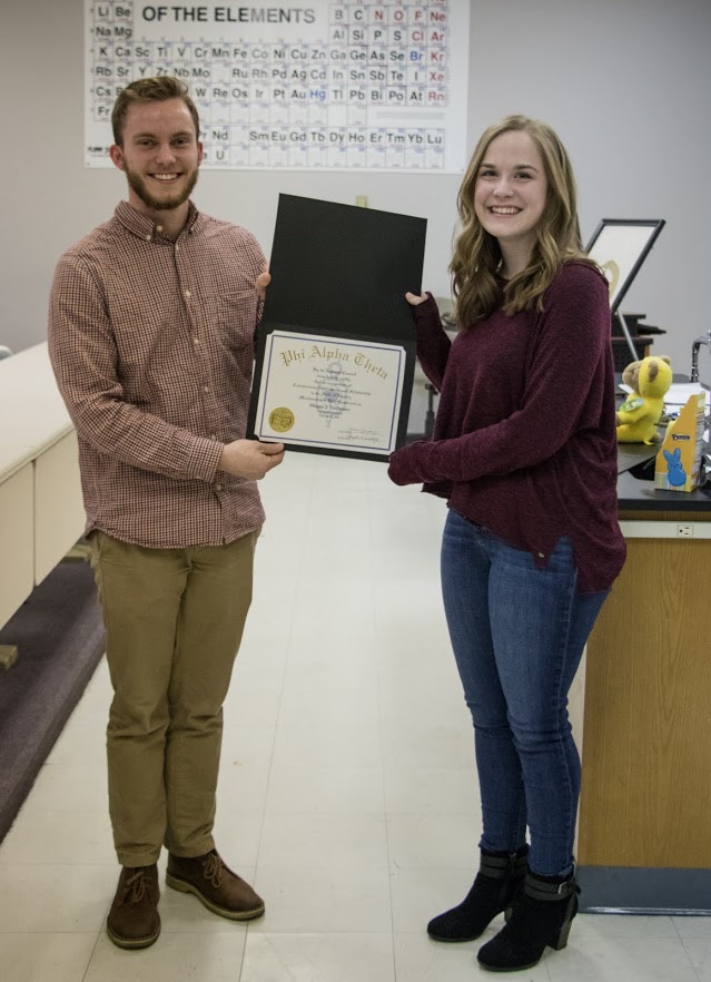Megan Ledbetter receives her Phi Alpha Theta certificate of membership from Delta-Psi President Seth Reid on February 27, 2018. Photo by Janelle Vest