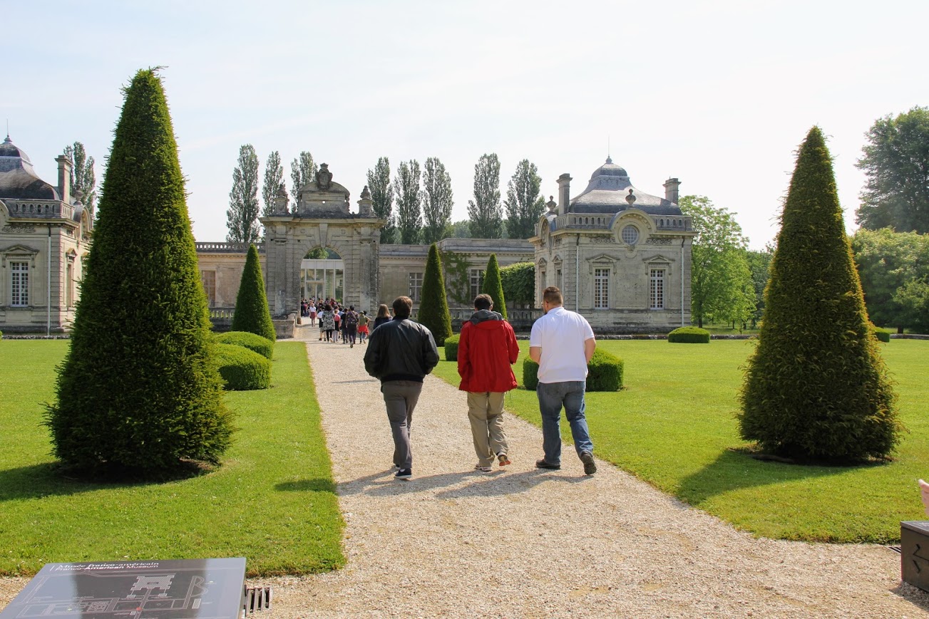 World War I tour members head toward the the Franco-American Museum at the Château de Blérancourt in Picardy, France, on May 25, 2018. They are (left to right, backs to camera) Micah Pinkley, Samuel Walgren, and Alex Carr.