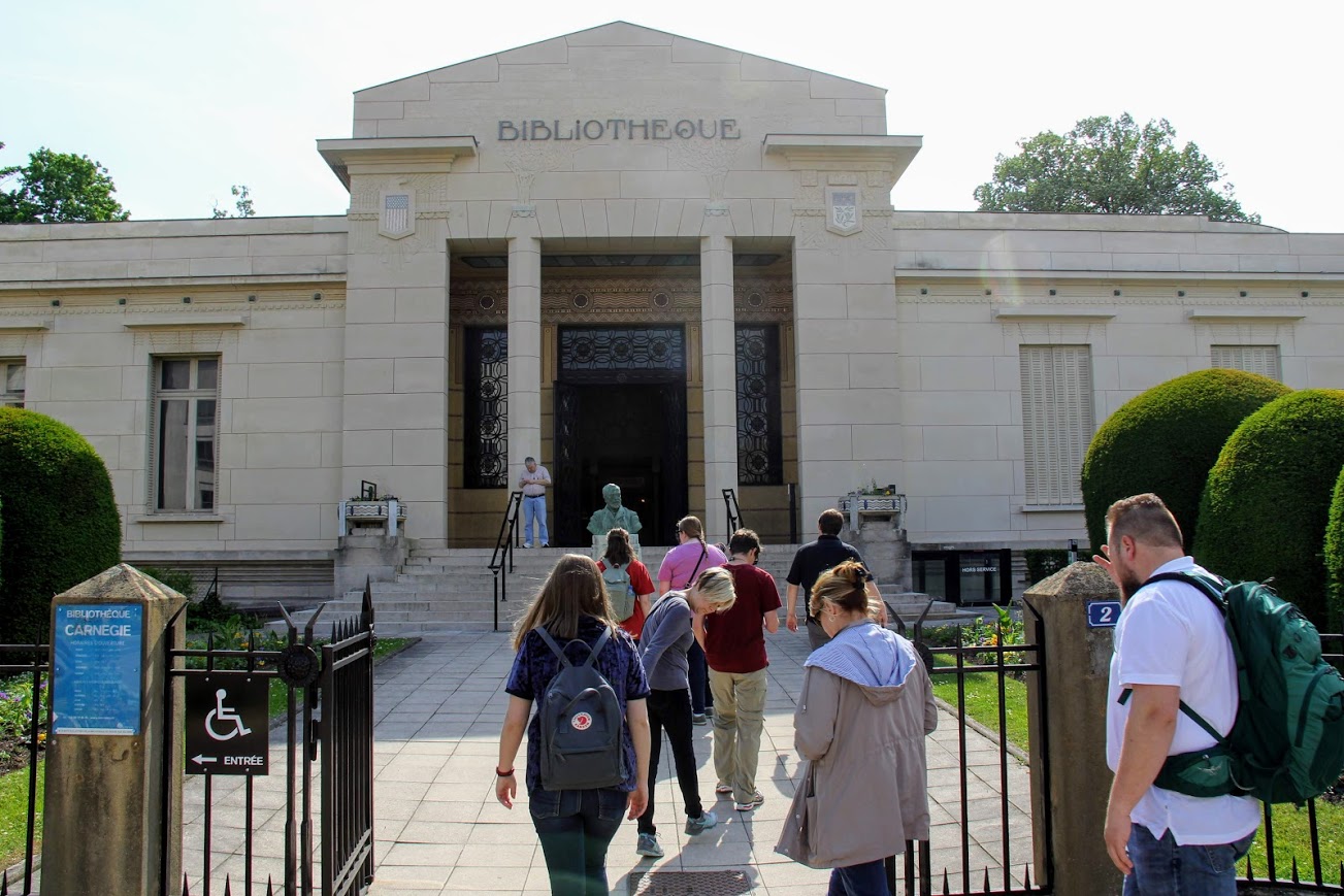 World War I tour participants enter the Carnegie Library of Reims, France, on May 25, 2018. American philanthropist Andrew Carnegie donated the money that was used to build the library in the 1920s as a part of the city's postwar reconstruction.