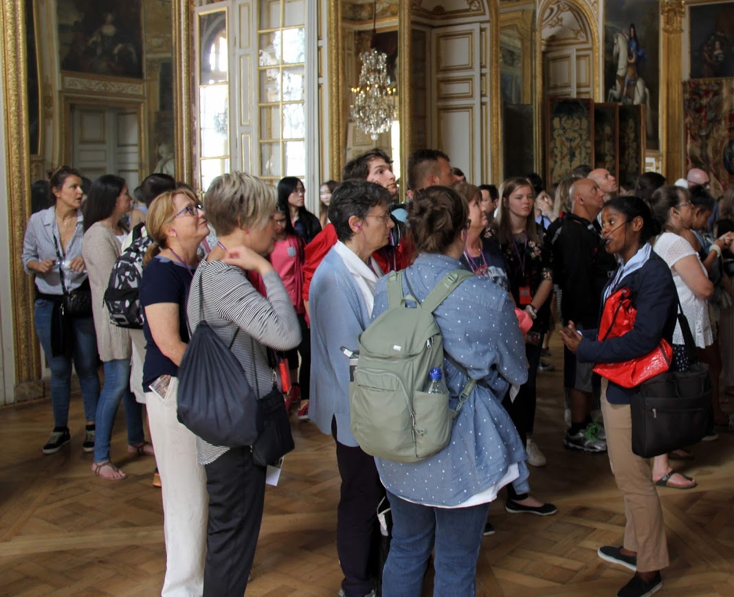 Tour guide Fabienne Germé (front right) talks to the West Tennessee travelers about one of the rooms at the Palace of Versailles on the morning of May 30, 2018.