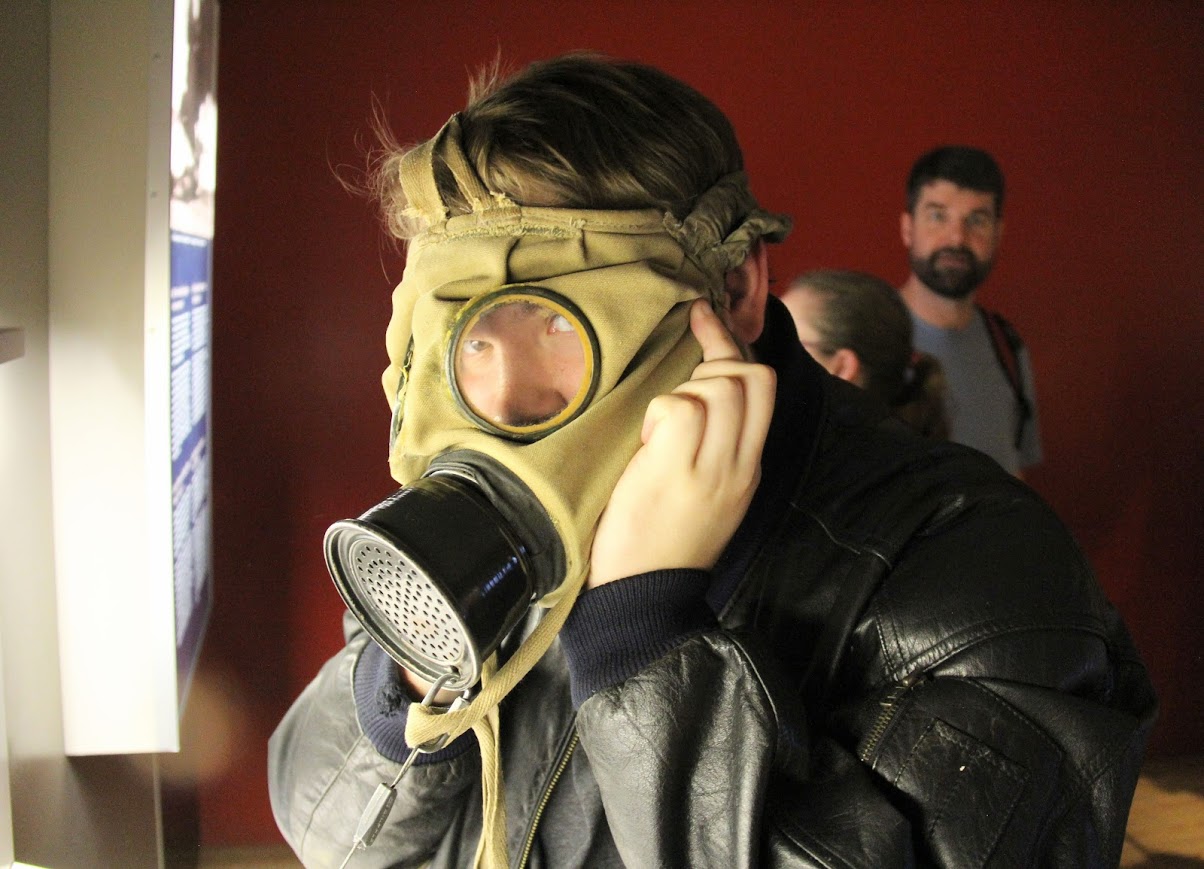 Micah Pinkley tries on a gas mask at the Memorial Museum Passchendaele 1917 in Zonnebeke, Belgium, on May 24, 2018.