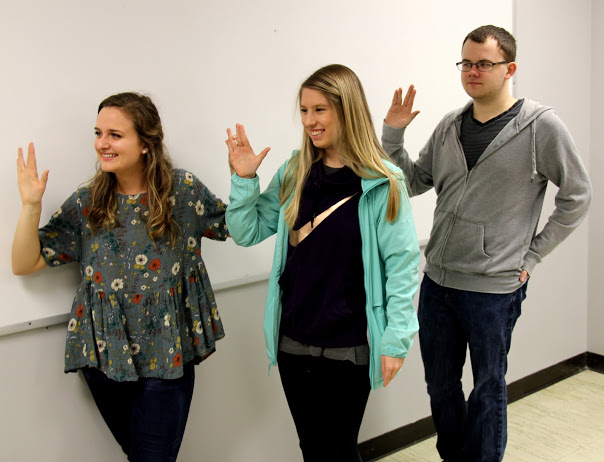 Emily Croft (left to right), Addison Osborne, and Will Choate take the induction oath at the Rutledge Honorary History Club's meeting on March 19, 2018.