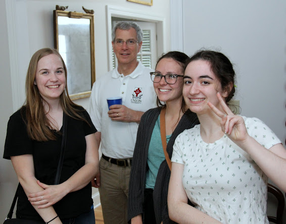 Megan Ledbetter (left to right), Dr. David Thomas, Katie Allison, and Leah Atkins pause for a photo during the Phi Alpha Theta cookout at Dr. Stephen Carls's home on May 12, 2018.