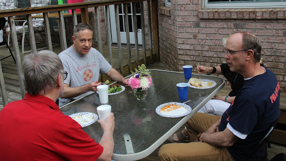 History department faculty members talk about history at the Phi Alpha Theta cookout on May 12, 2018. They are (left to right, moving clockwise) Dr. Terry Lindley, Dr. Henry Allen, and Robert Briley. Largely obscured in the photo is Brenda Briley, who is seated to Robert Briley's right.