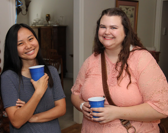 Phi Alpha Theta members Katherine Cheshire (left) and Jessica Barton enjoy a relaxing moment at the history department cookout on May 12, 2018.