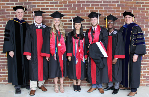 Graduating history majors and Phi Alpha Theta members stand with history department faculty members at Union University's spring graduation on May 19, 2018. Those in the photo are: (left to right) Dr. Stephen Carls, Holden Bennett, Ali Renckens, Katherine Cheshire, Seth Reid, Cedric Davis, and Dr. Keith Bates.