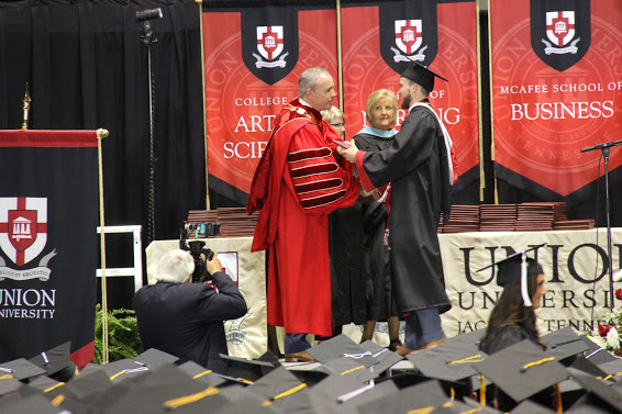 Dr. Samuel W. Dub Oliver presents Seth Reid with his diploma at Union University's commencement exercises on May 19, 2018.