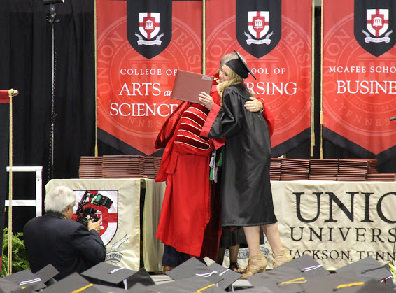 Dr. Samuel W. Dub Oliver gives a congratulatory hug to graduating Phi Alpha Theta member Ali Renckens after presenting her with her diploma at Union University's commencement exercises on May 19, 2018.