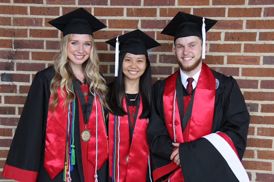 Graduating Phi Alpha Theta members stand together prior to Union University's spring graduation at the Oman Arena on May 19, 2018. They are (left to right) Ali Renckens, Katherine Cheshire, and Seth Reid.