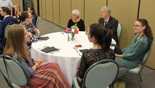 Attendees at the history awards banquet on May 3, 2018, engage in conversation at the beginning of the evening's activities. They are (left to right, going clockwise) Megan Ledbetter, Will Choate, Nancy Thomas, Dr. David Thomas, Katie Allison, and Lauren Butler (back to camera).