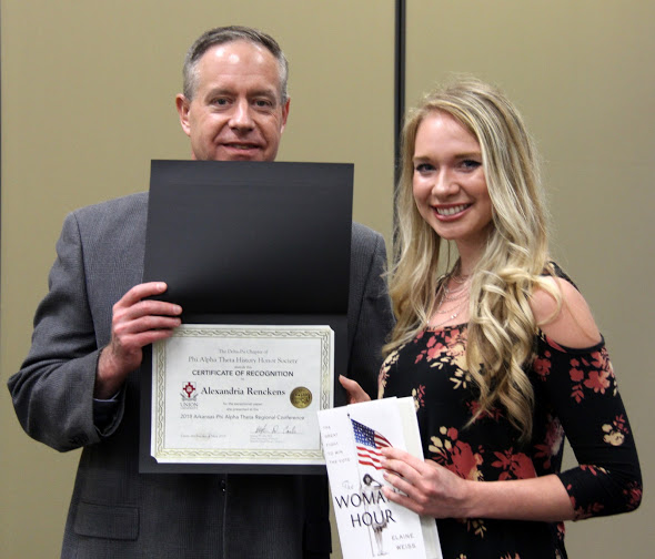Ali Renckens receives a recognition certificate and a book from Dr. Henry Allen at the history awards banquet on May 3, 2018, for her paper presentation at the Arkansas Phi Alpha Theta Regional Conference on April 7, 2018. Photo by Katherine Cheshire