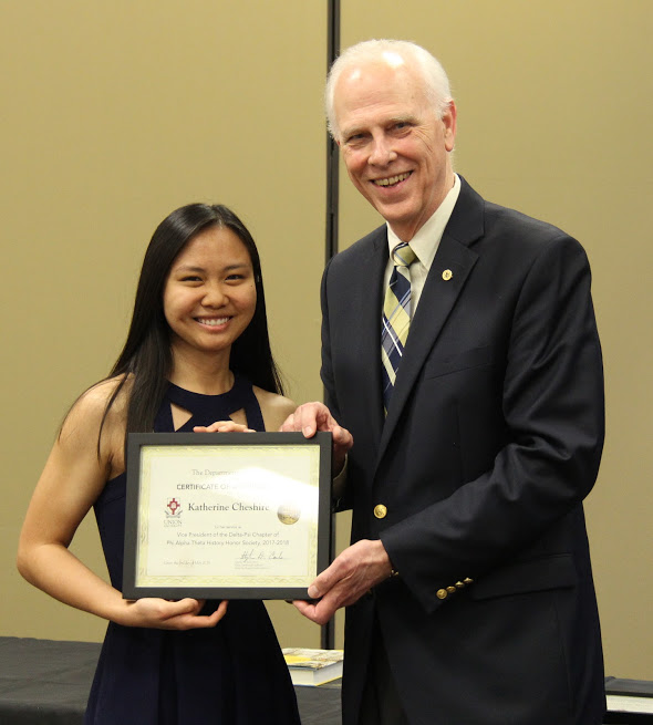 Katherine Cheshire accepts a certificate of appreciation from Dr. Stephen Carls at the history awards banquet on May 3, 2018, for her work as vice president of Union's Delta-Psi chapter of Phi Alpha Theta in 2017-2018. Photo by Catherine Carls