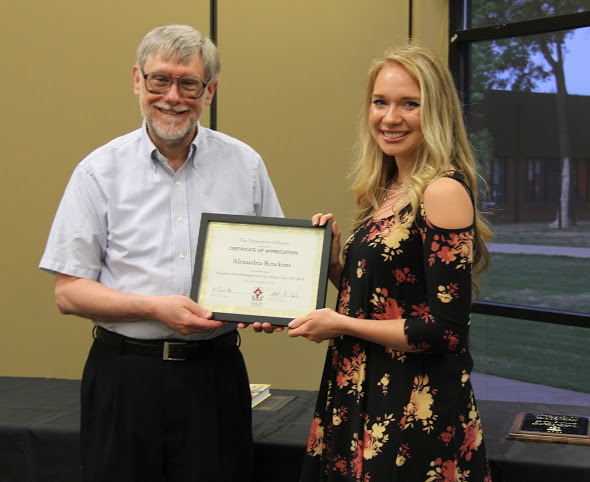 Ali Renckens accepts a certificate of appreciation from Dr. Terry Lindley at the history awards banquet on May 3, 2018, for her work as president of the Rutledge Honorary History Club in 2017-2018. Photo by Katherine Cheshire