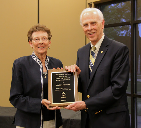 Beverly Smothers accepts the 2018 History Alumni Distinguished Achievement Award from Dr. Stephen Carls at the history awards banquet on May 3, 2018. Photo by Katherine Cheshire