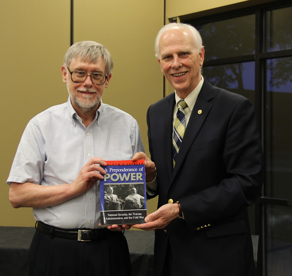 Dr. Stephen Carls (right) presents a book to Dr. Terry Lindley on May 3, 2018, in recognition of Lindley's 26 years of service as faculty advisor to the Rutledge Honorary History Club. Photo by Katherine Cheshire