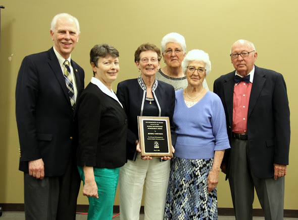 Beverly Smothers (holding plaque), the 2018 recipient of the Tenth Annual History Alumni distinguished Achievement Award, stands with (left to right) Dr. Stephen Carls, Dr. Alice-Catherine Carls, Linda Hutcheson, Marilyn Smothers, and Marion Smothers at the end of the history awards banquet on May 3, 2018. Photo by Katherine Cheshire