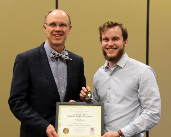 Robert Briley (left) presents the Phi Alpha Theta Scholarship Pin and Academic Excellence Certificate to Seth Reid at the History Department Awards Banquet on May 3, 2018. Photo by Katherine Cheshire