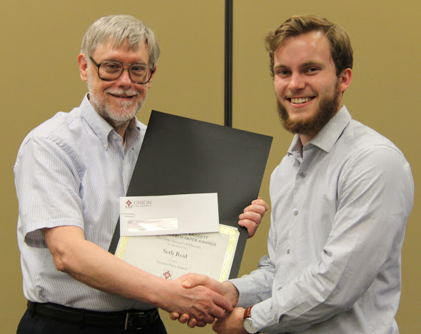 Seth Reid (right) accepts the second place award in the Dr. James Alex Baggett History Research Paper Competition from Dr. Terry Lindley at the history awards banquet on May 3, 2018. Photo by Katherine Cheshire