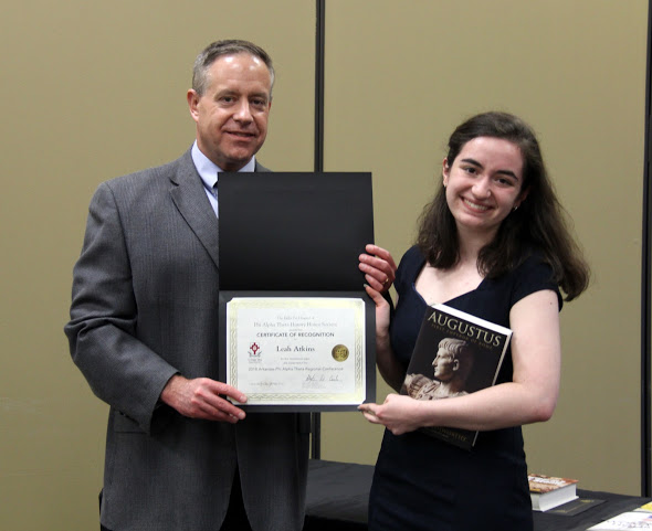 Leah Atkins accepts a book and a certificate of recognition from Dr. Henry Allen at the history awards banquet on May 3, 2018, for her paper presentation at the Arkansas Phi Alpha Theta Regional Conference on April 7. Photo by Katherine Cheshire