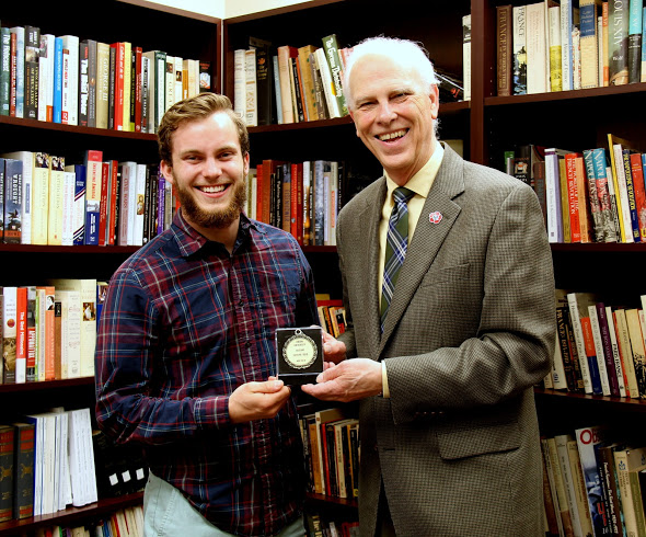 Dr. Stephen Carls (right) presents Union University's Academic Excellence Medal in History to history major Seth Reid on May 10, 2018.