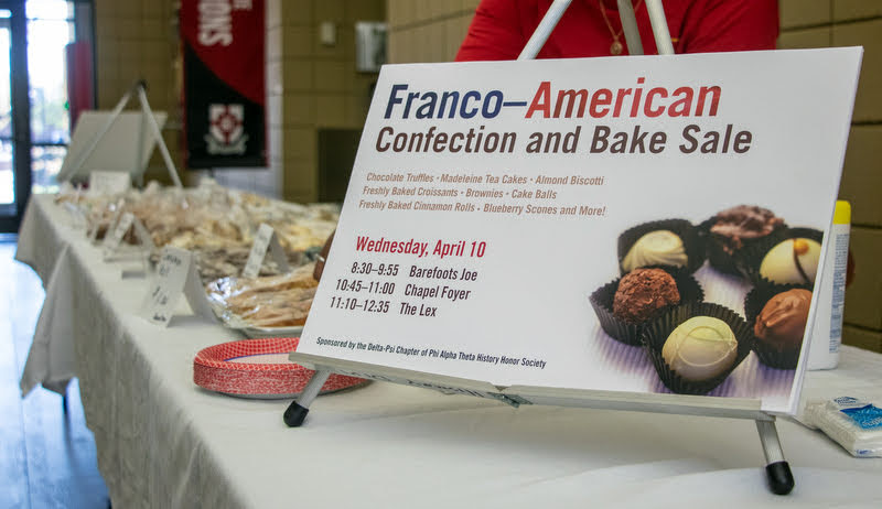 A sign announces the Franco-American bake sale in the Student Union Building on April 10, 2019. Photo by Joey Echeverria.