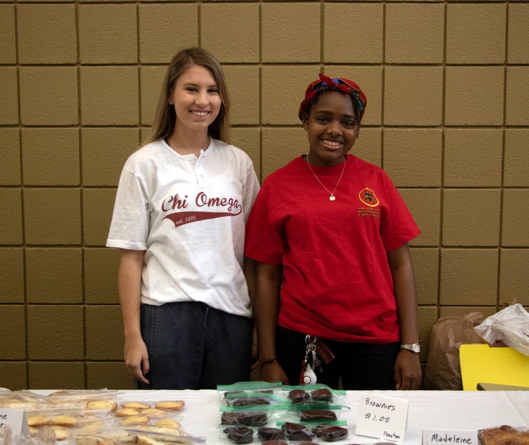 Addison Osborne (left) and Tranae Newsome stand together at the beginning of the Phi Alpha Theta bake sale on April 10, 2019. Photo by Joey Echeverria