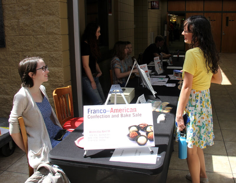 Lauren Butler (left) talks to Phi Alpha Theta member Lillie Salazar near the Lexington Inn during the last stage of the Delta-Psi chapter's bake sale on April 10.