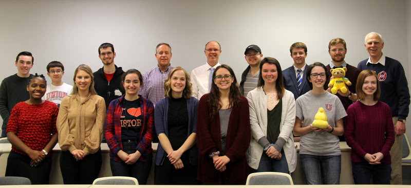 Delta-Psi chapter members stand for a group photo at their spring plenary meeting on February 26. 2019. They are (front row, left to right) Tranae Newsome, Addison Osborne, Leah Atkins, Megan Ledbetter, Katie Allison, Audrey Cagle, Lauren Butler, and Savannah Wright; (back row, left to right) Mac Hazlerig, Matthew Allen (son of Dr. Henry Allen), Matthew Latham, Dr. Henry Allen, Robert Briley, Will Choate, Reagan Smith, Luke Sower, and Dr. Stephen Carls.