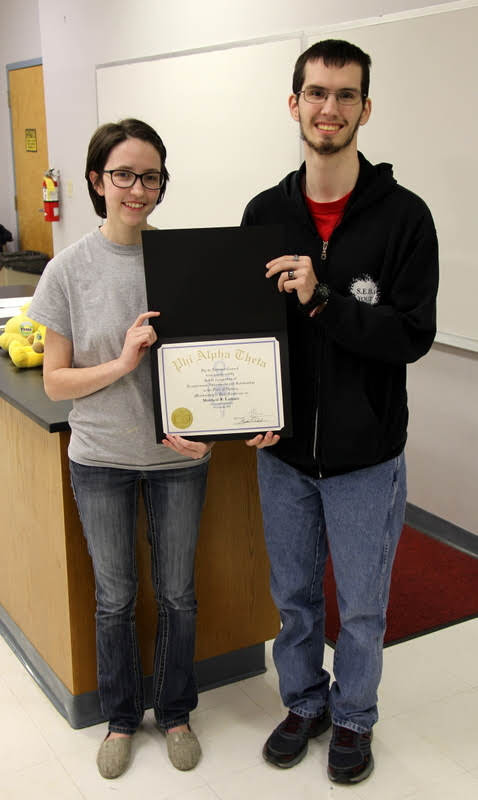 Matthew Latham receives his Phi Alpha Theta membership certificate from Delta-Psi President Lauren Butler on February 26, 2019.