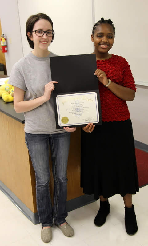 Tranae Newsome (right) accepts her Phi Alpha Theta membership certificate from Delta-Psi President Lauren Butler on February 26, 2019.