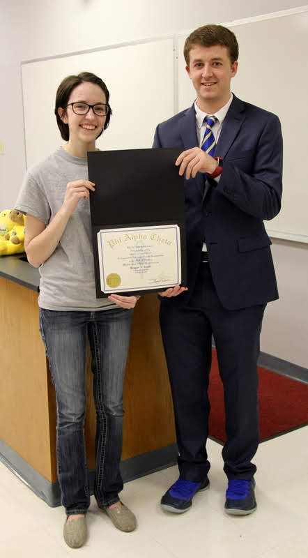 Reagan Smith receives his Phi Alpha Theta membership certificate from Delta-Psi President Lauren Butler on February 26, 2019.