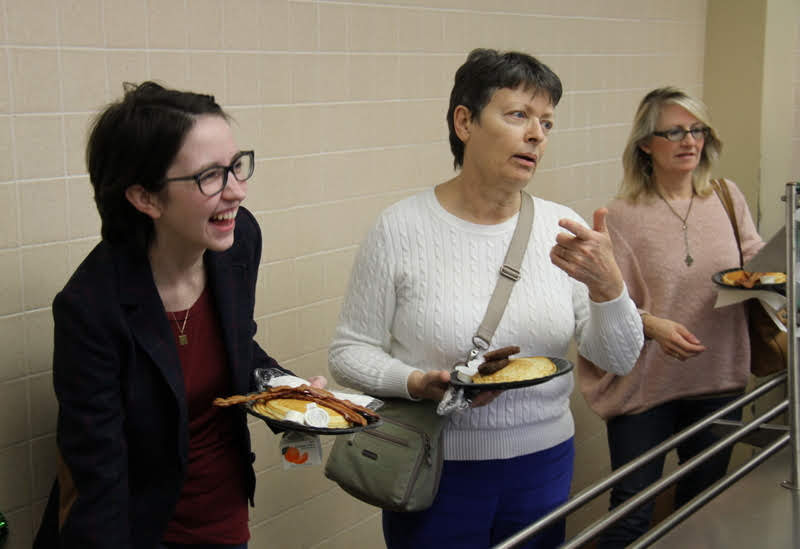 Dr. Alice-Catherine Carls (center) talks with some Old Hickory Rotary Club servers at the club's annual pancake breakfast. On the left is Delta-Psi Chapter President Lauren Butler, and on the right is Brenda Briley.